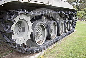 Quad tracked tank on the green lawn.