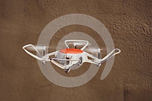 Quadcopter drone in flight with digital camera.