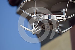 Quadcopter drone in flight with digital camera.