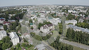 A quadcopter flies over an old Russian city on a beautiful summer day