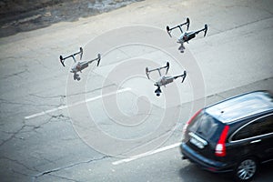 Quadcopter UAV`s drones for commercial aerial photography fly over motorway, at caught up with the pursuit keeps track of a car.
