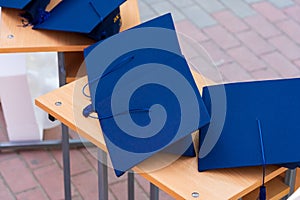 Quadrangular cap as a symbol of a graduate. Background with selective focus and copy space