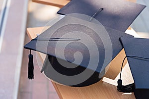 Quadrangular cap as a symbol of a graduate. Background with selective focus and copy space