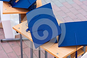 Quadrangular cap as a symbol of a graduate. Background with selective focus and copy space