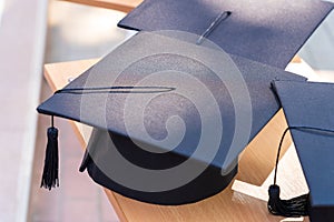 Quadrangular cap as a symbol of a graduate. Background with selective focus and copy space