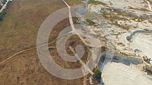 Quadrocopter flies over field and quarry