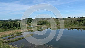 Quadrocopter flying over Gorodishchensky lake. Izborsk, Russia