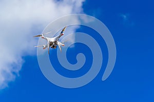 Quadrocopter flying in the sky. Modern dron in the air with camera. photo