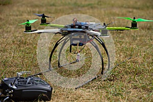 Quadrocopter with remote control on the grass