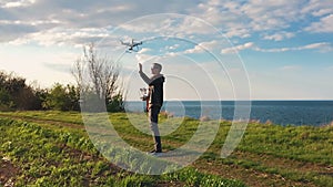 Quadrocopter takes off from the pilot`s hand in slow motion. Running the Dron.