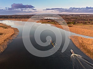 Quadruple crew practice in River Corrib, Galway, Ireland. Warm sunny day, Cloudy sky. Aerial drone view