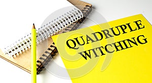 Quadruple Witching text written on a yellow paper with notebook