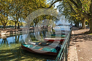 Quai Jules Philippe, a canal in the shade of plane trees, and boats on Lake Annecy, in Haute Savoie, France