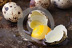 Quail egg broken on rustic table