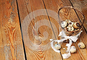 Quail eggs in a basket on a wooden table