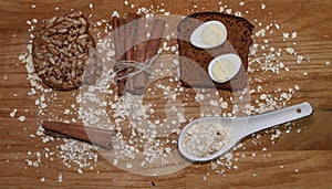Quail eggs on a black bread and oat chips and cookie and a cinnamon stick