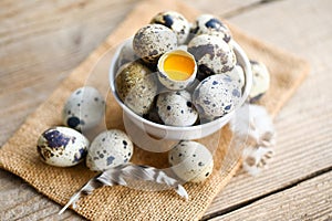 quail eggs on bowl, fresh quail eggs on wooden table background, raw eggs with peel egg shel