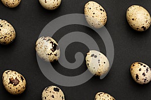 Quail eggs close-up on a black backgroundHoliday easter, minimalistic black composition