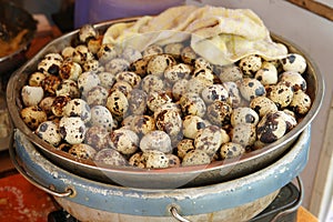 Quail eggs displayed in a bowl at market in Hong Kong