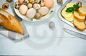 Quail eggs and hen egg with bread and butter