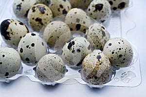 Quail eggs in plastic packaging. Quail eggs on a white background. A delicious snack