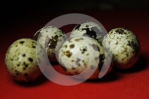 Quail eggs on red background