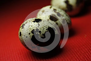 Quail eggs on red background