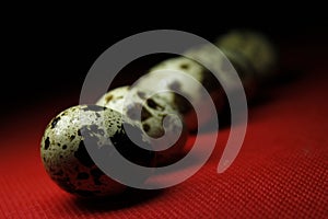 Quail eggs on red background