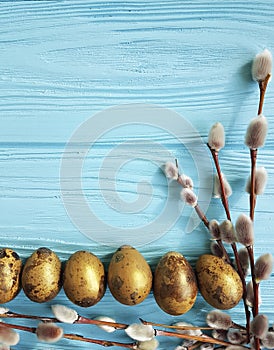 Quail eggs willow seasonal springtime happy easter blue wooden background