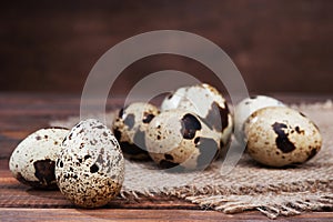 Quail eggs on wooden background close-up