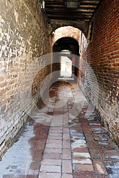 Empty narrow italian alleywayin Venice, Italy photo