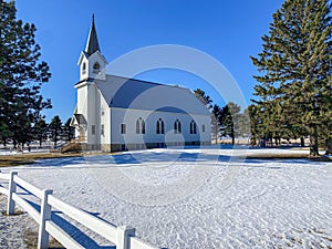 A quaint country church in the middle of a frozen winter