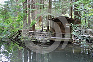 Quaint fishing shack on river.