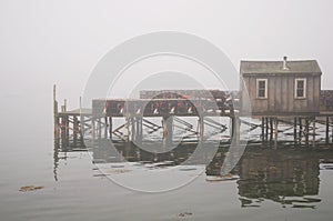 Quaint fishing wharf in fog photo