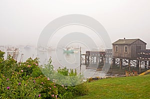 Quaint fishing wharf in fog