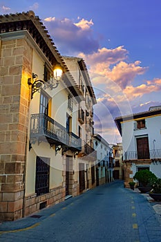 Quaint houses with lit street lamps in a white village of Almeria, Velez Rubio, Spain. photo