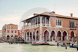 Quaint marketplace with an array of fruits and vegetables, located alongside Venice\'s majestic Grand Canal