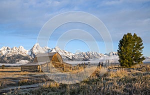 quaint Moulton barn wintry autumn weather on snow capped Grand Teton national Park in Wyoming