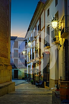 Quaint narrow alley at dusk in the Andalusian village of Velez Rubio, Almeria, Spain. photo