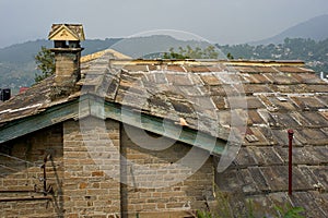 A quaint, old structure with stone walls,chimney roof slanting stone roofs  Almora Uttarakhand