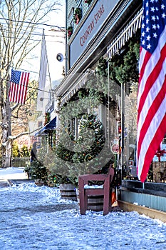 Quaint Street in Small Town USA during Christmas Holiday Displaying American Flags