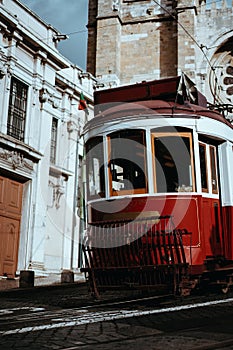 Quaint tram passes directly in front of the Se Cathedral in Lisbon. Lisboa Lissabon