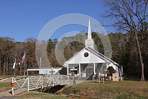 Quaint white church in rural East Texas adorned with Christmas decorations under a clear blue sky