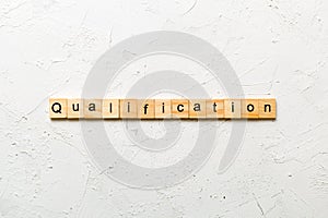 qualification word written on wood block. qualification text on table, concept