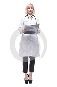 qualified female doctor looking at an x-ray .