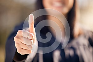 Qualified in whatever career I choose to have. an unrecognisable woman showing thumbs up on graduation day.