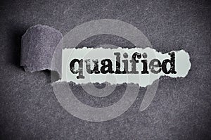 Qualified word under torn black sugar paper photo