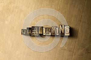 QUALIFYING - close-up of grungy vintage typeset word on metal backdrop photo