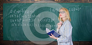 Qualities that make good teacher. Principles can make teaching effective. Woman teaching near chalkboard in classroom