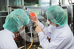 Quality control and food safety staff team inspection products contaminate standard in the food and drink factory production line